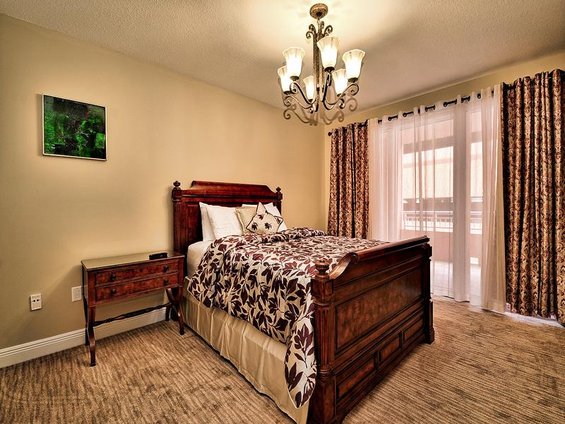 Guest bedroom 2 has a queen bed and access to it's own balcony.